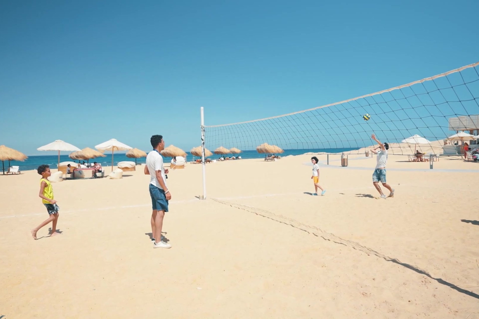 Families playing volleyball on BOHO Sokhna beach during Eid