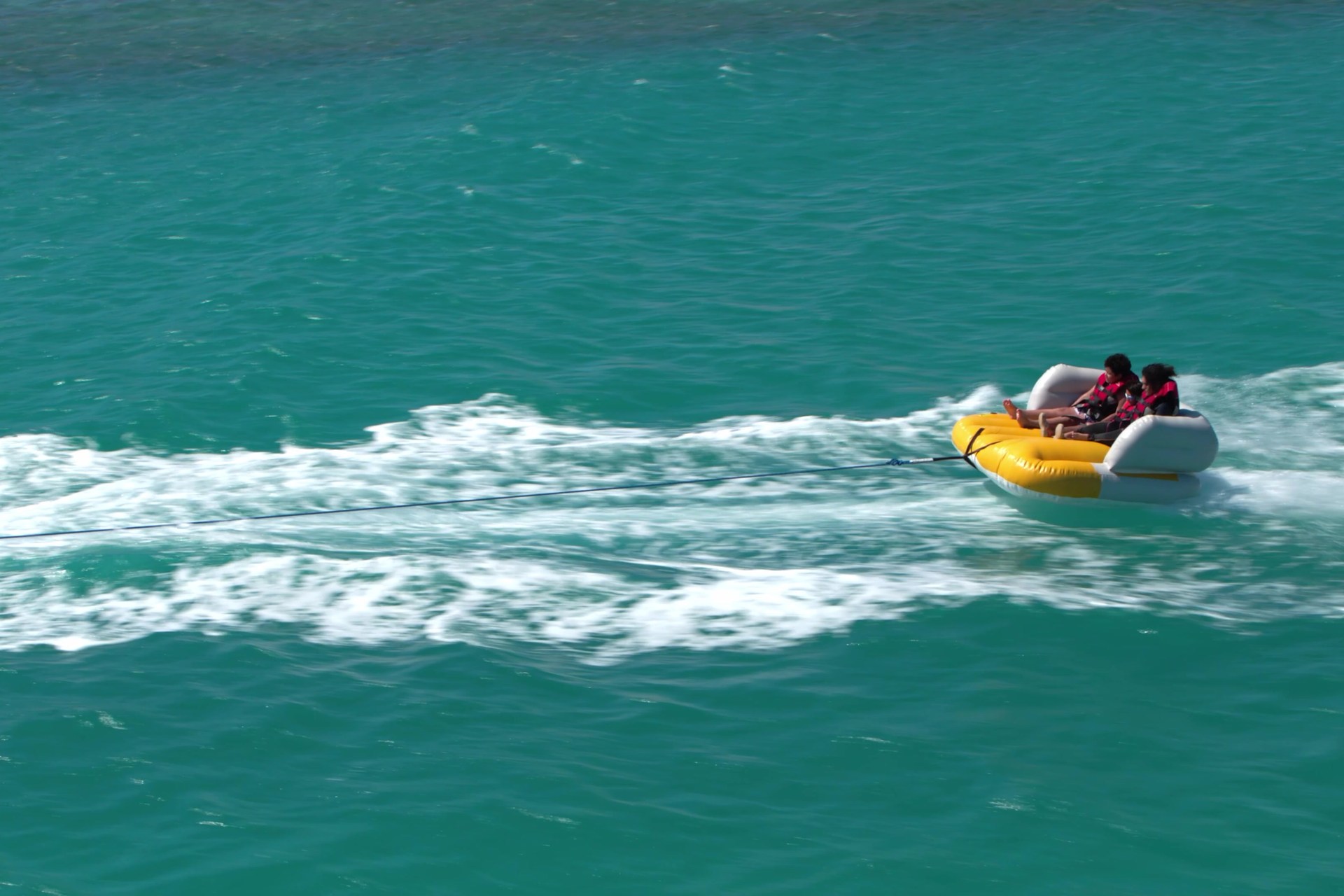 Guests on a towable water ride off the BOHO Sokhna shore