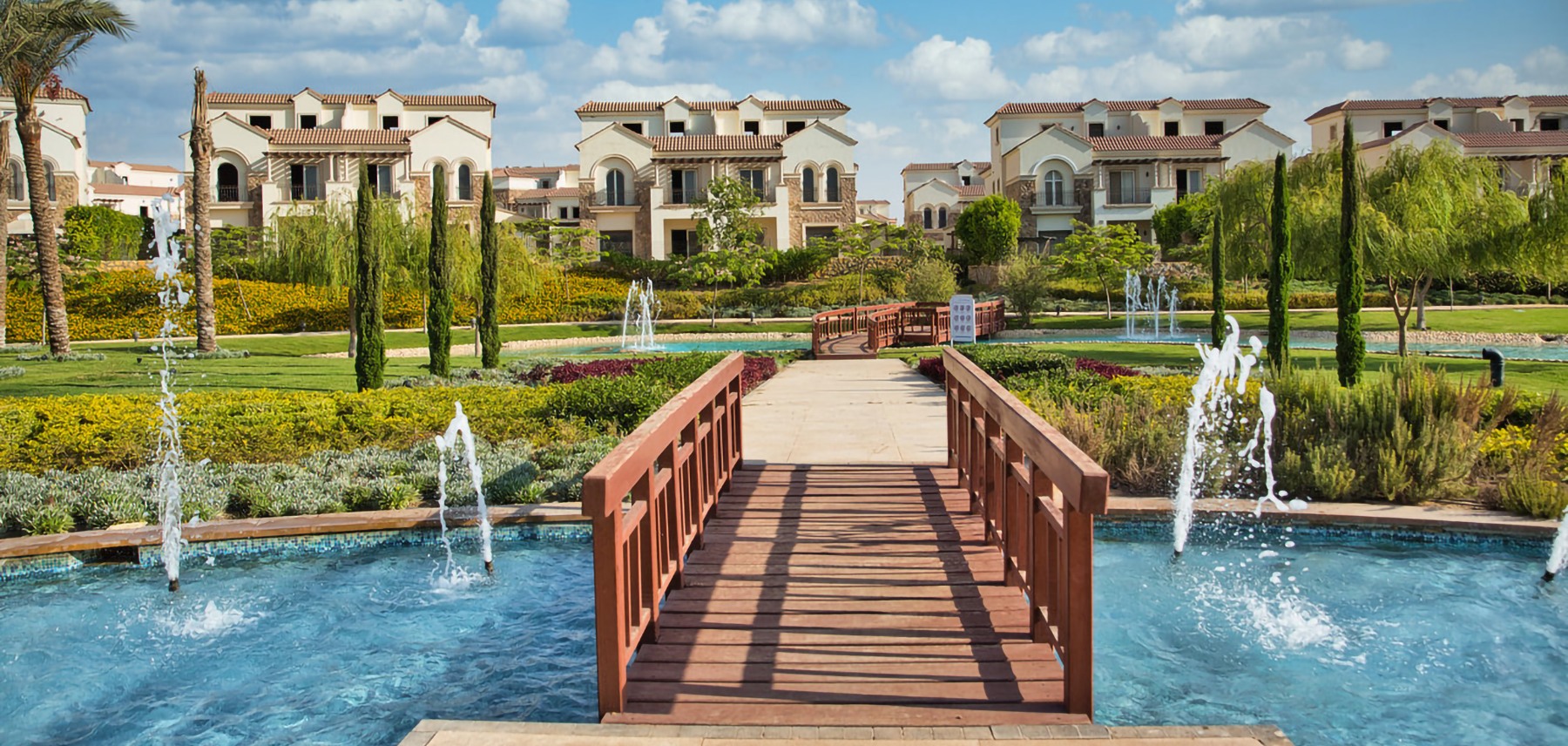 Footbridge and fountains within Divina Gardens