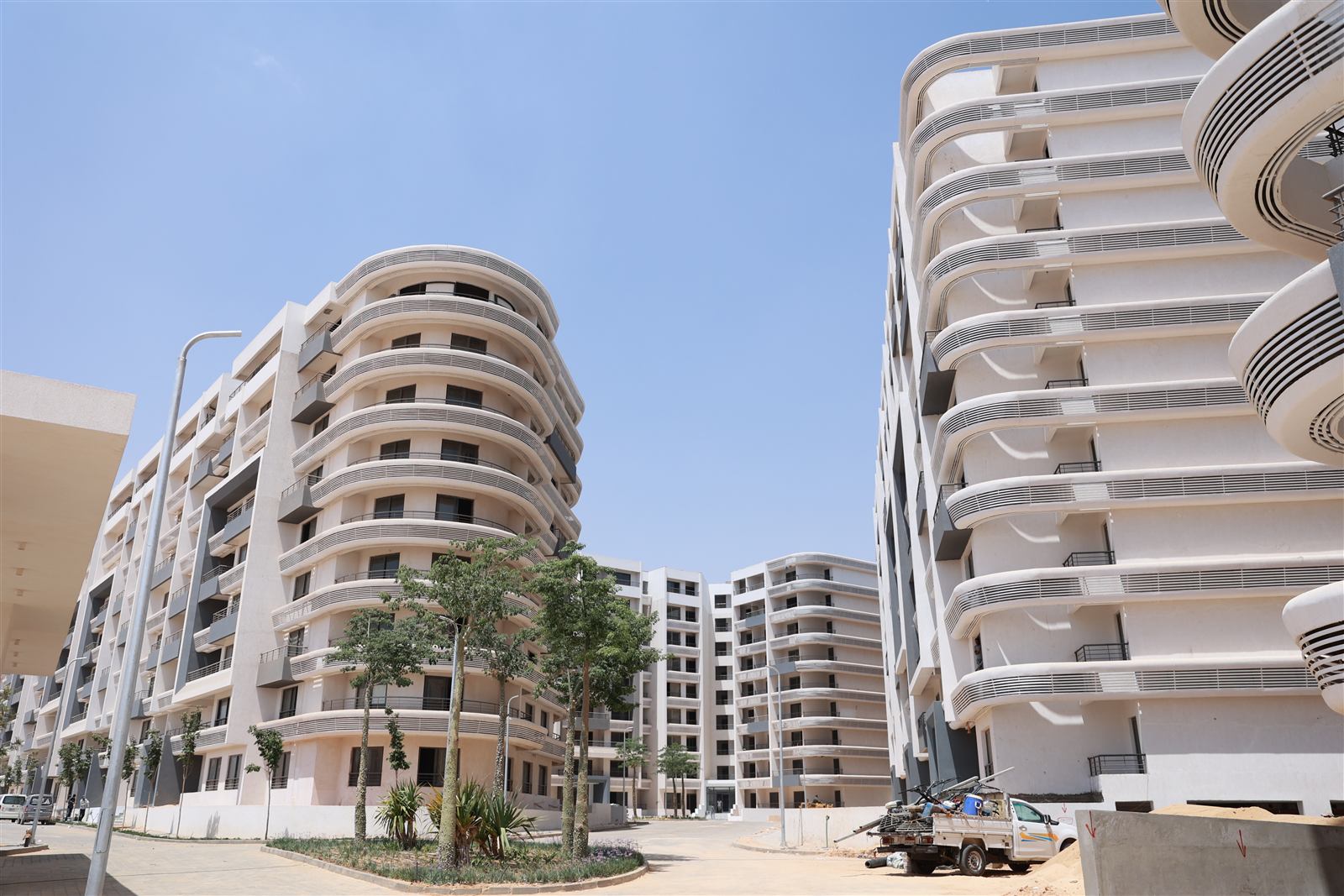 Boardwalk buildings and young street trees, July 2026